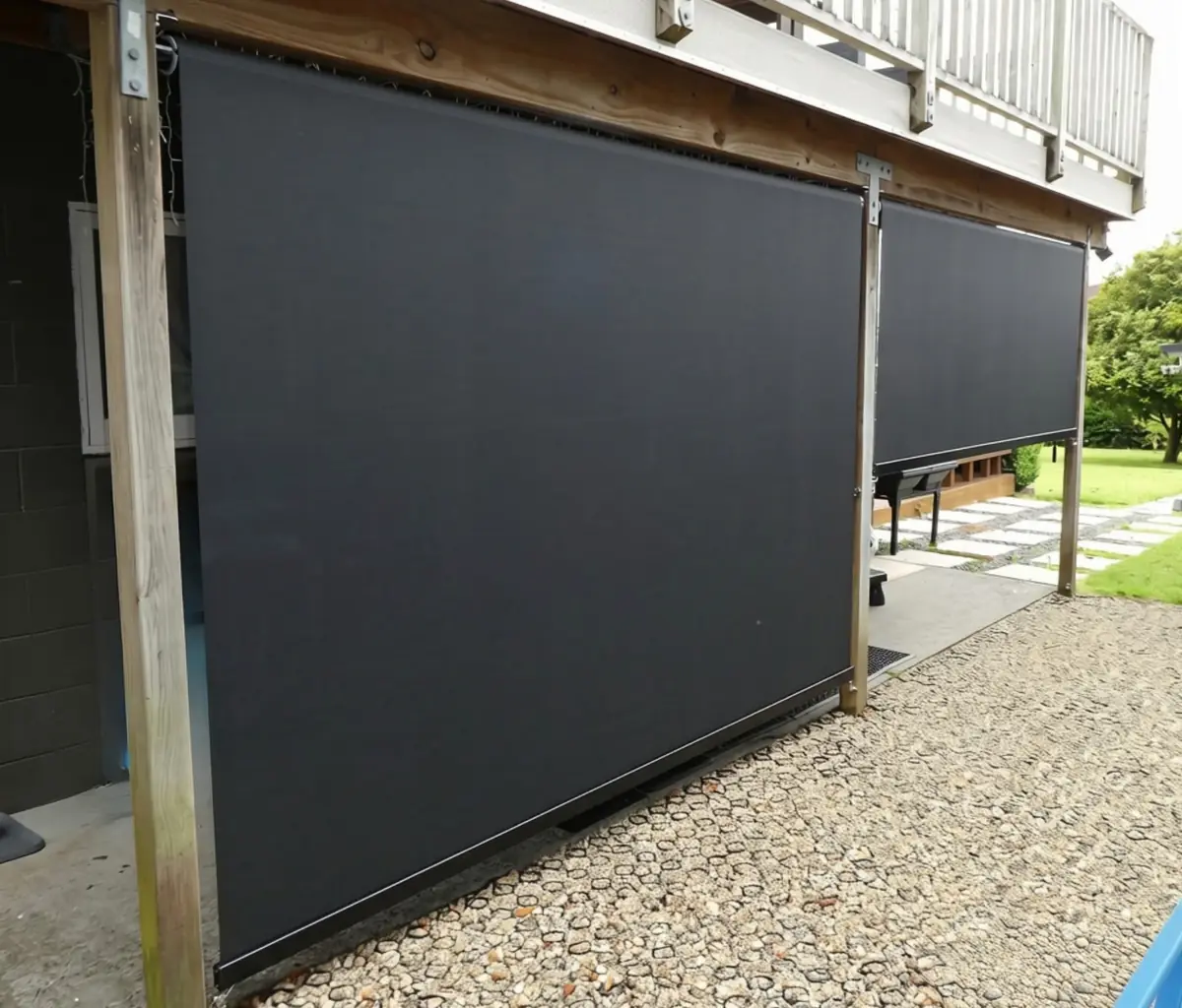 Black mesh outdoor blinds beneath a deck